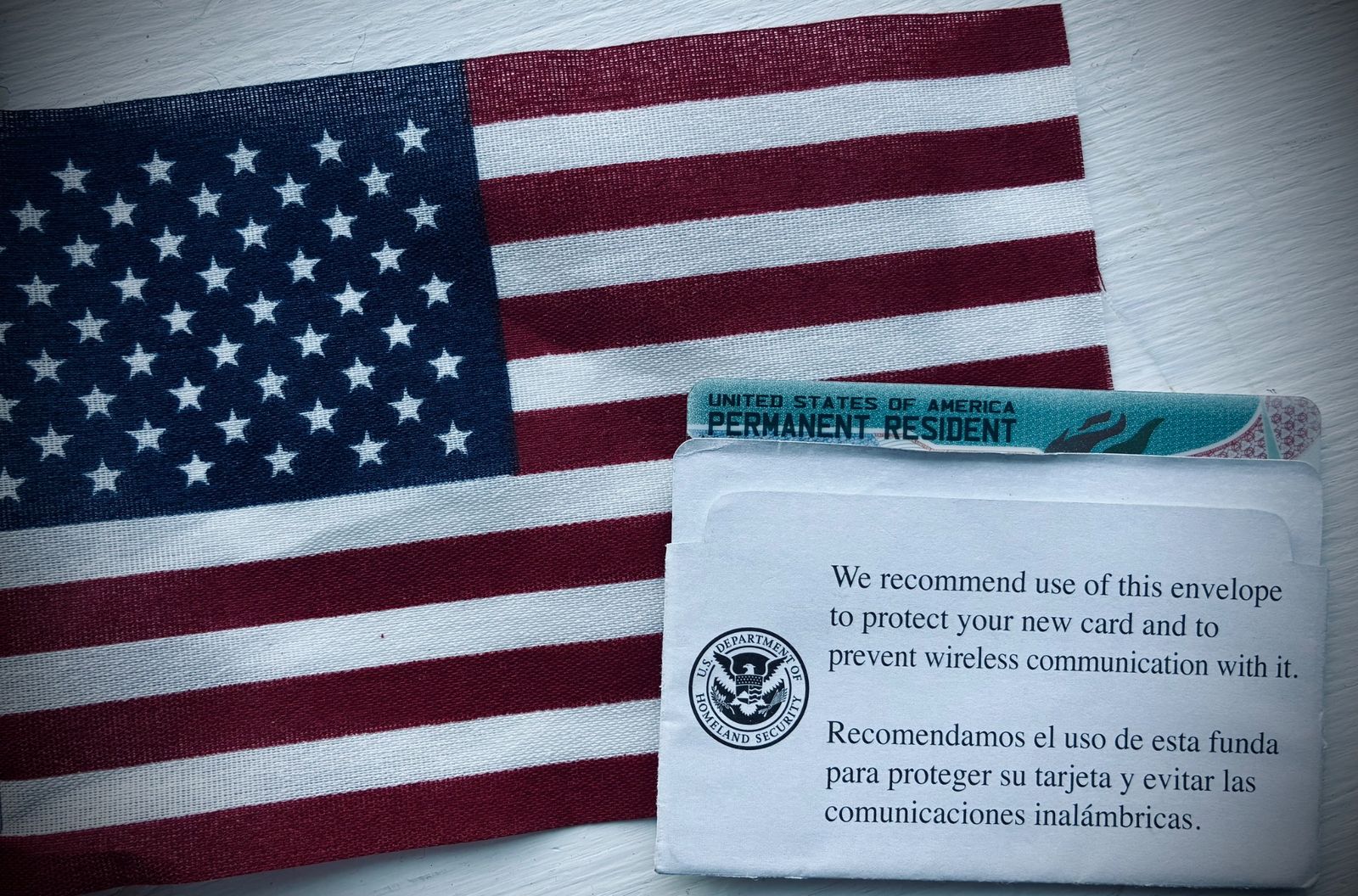 American flag with US Permanent Resident card